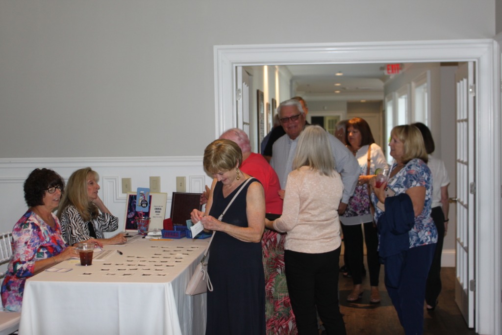 Left to Right:  Cheryl Dempsey and Denise Harris greeting classmates